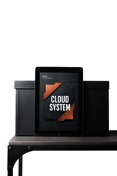 A tablet device displaying a 'CLOUD SYSTEM' graphic, flanked by two black speaker-like boxes on a dark table against a white background.